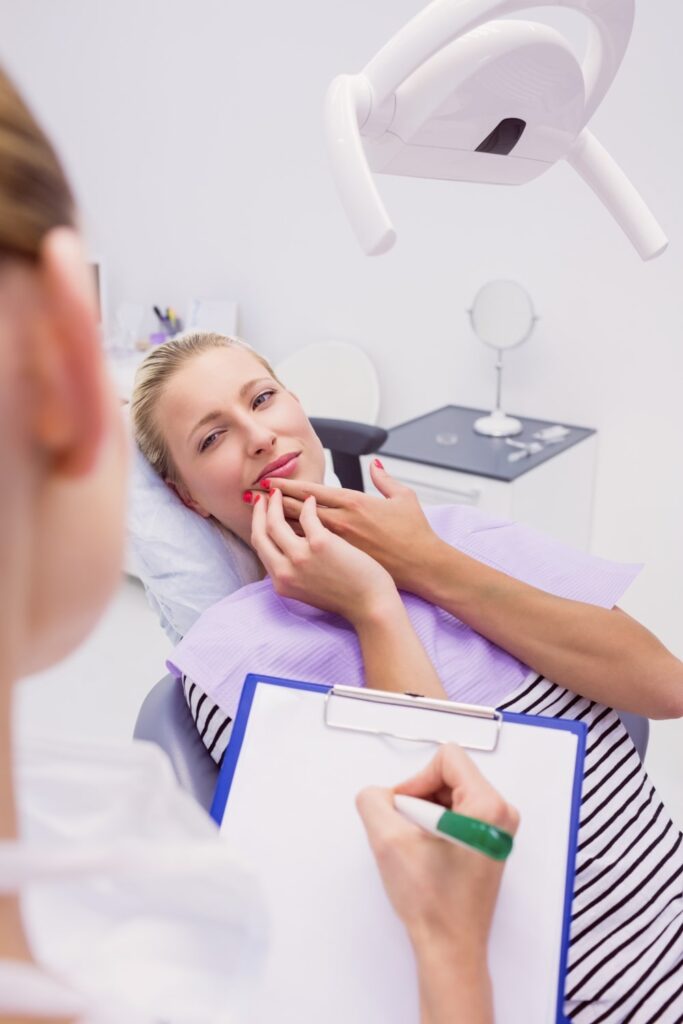 female patient at the dentist with gum disease looking for a treatment