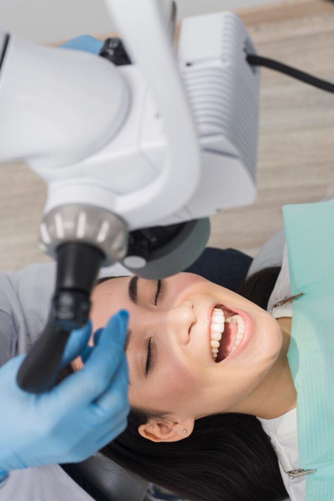 dentist doing a dental deep cleaning to a patient woman from Charlotte NC