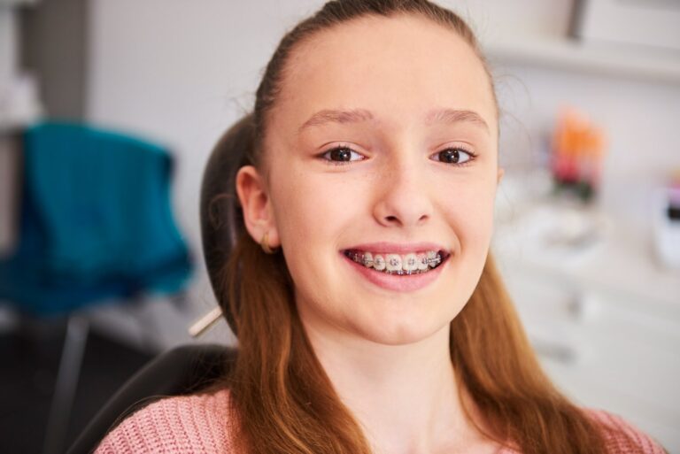 portrait smiling child with braces in dentist office happy to know if do i need braces