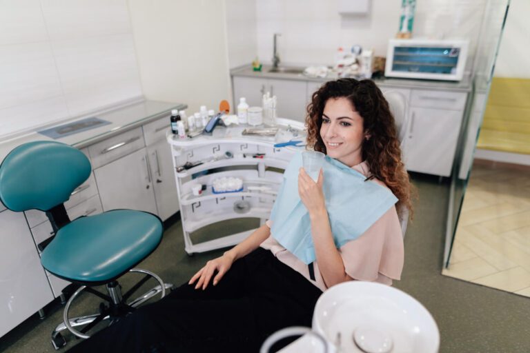 Smiling woman at the dentist office knowing if is a root canal worth it