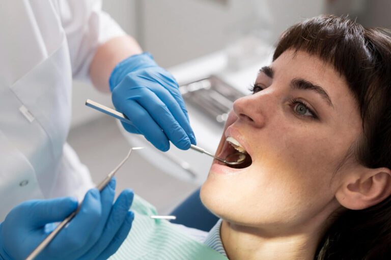 Young female patient having dental procedure at the dentist learning the signs of needing a root canal