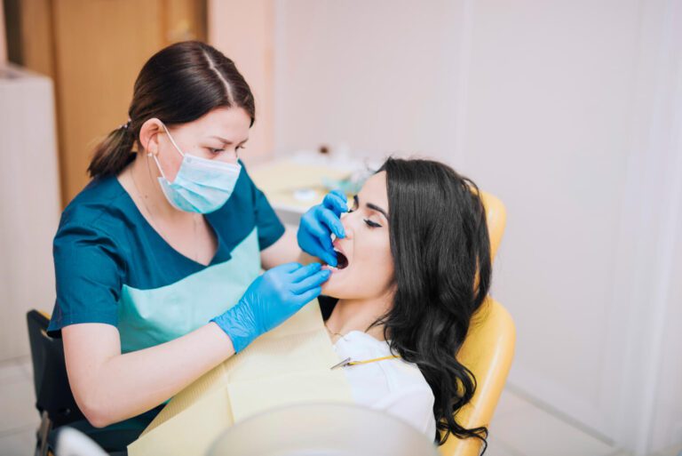 Dentist curing teeth of patient explaining how to know if your wisdom teeth are coming in