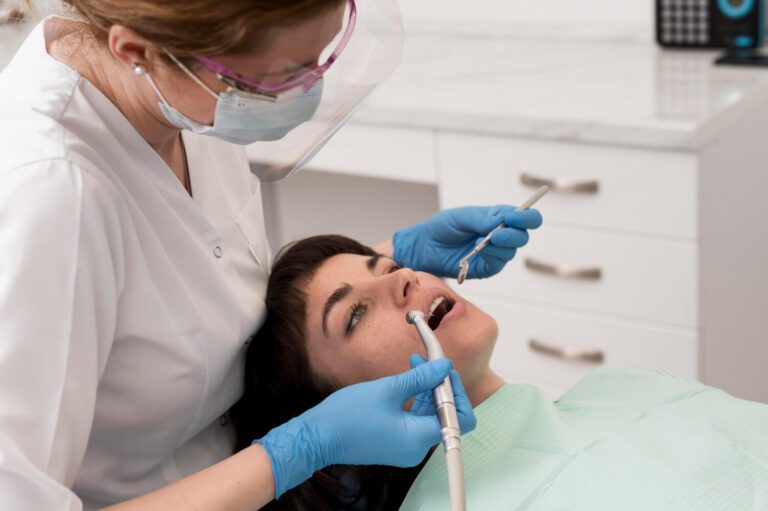 Female patient having a procedure done at the dentist knowing the signs a tooth needs to be pulled