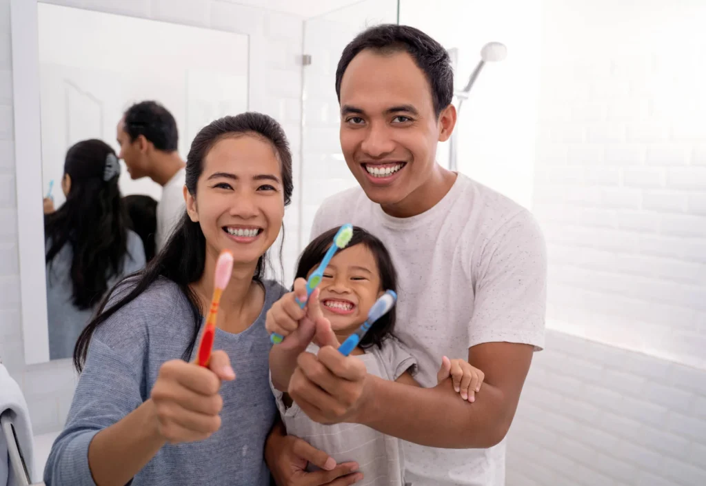 Family brushing together with help from dental offices in Charlotte.